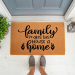 Family Makes This House A Home coir doormat featuring black script text on a natural fiber welcome mat, placed at a front door entrance for a stylish porch decor look that adds a warm, inviting touch to any home entryway.