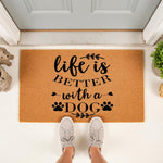 Life is better with a dog doormat featuring black text and paw prints on a natural coir fiber welcome mat, placed on a front porch for pet lovers who want a stylish outdoor rug for their home entryway and dog decor for the front