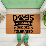 Dogs Welcome People Tolerated doormat featuring a paw print design on natural coir fiber, this funny front porch welcome mat is a durable outdoor rug for pet lovers who want a humorous entryway decor piece for their home entrance.