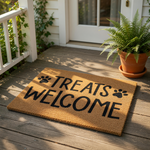 Treats Welcome doormat with black paw prints on a natural coir fiber mat, this funny dog lover welcome mat is a durable outdoor rug for pet owners who want a cute front porch entrance decor piece for their home or apartment