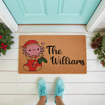 Personalized Christmas axolotl doormat featuring a cute pink axolotl in a Santa hat inside a stocking, perfect for a holiday welcome mat.