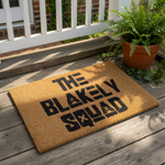 Personalized family name doormat featuring bold black text on a natural coir fiber welcome mat, perfect for a front porch entry.