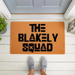 Personalized family name doormat featuring bold black text on a natural coir fiber welcome mat, perfect for a front porch entry.
