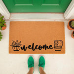 Cactus welcome doormat featuring a natural coir fiber texture with black succulent and cactus plant illustrations, perfect for a front porch entry way decor, housewarming entrance mat, or a stylish outdoor welcome rug for your