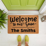 Personalized family name welcome doormat featuring a natural coir fiber texture and black script lettering, perfect for a front porch entry way decor update that adds a custom touch to your home entrance and outdoor floor mat