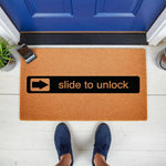 Slide to unlock doormat featuring a humorous phone-inspired design on natural coir fiber, this funny welcome mat for front porch entryways adds a clever tech-themed touch to your home decor and makes a unique housewarming gift.