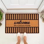 Personalized family name welcome doormat featuring a black and natural coir striped design, perfect for a front porch entry.
