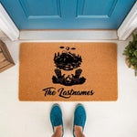Personalized camping doormat featuring a mountain lake and campfire scene, this custom outdoor welcome mat for home entryways is a durable coir rug that makes a great housewarming decor piece for any family last name.