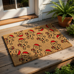 Gingerbread man Christmas doormat featuring a festive pattern of smiling cookies wearing red Santa hats and holding candy canes on a natural coir welcome mat, perfect for holiday porch decor and seasonal entryway floor mats.