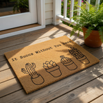 Funny cactus doormat with the text It Succs Without You Here, featuring four potted succulent illustrations on a natural coir welcome mat, perfect for a housewarming gift or a humorous front porch decor entry rug for plant lovers.