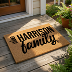 Personalized family name coir doormat featuring custom text on a natural fiber welcome mat, perfect for a front porch entry, housewarming, or new home decor gift for a family looking for a durable, stylish outdoor floor rug.