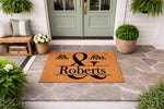 Personalized Mr. and Mrs. family name coir doormat for front porch decor, featuring a durable natural fiber welcome mat with custom last name lettering, perfect for a wedding gift or new home housewarming entrance floor mat.