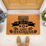 Hanukkah welcome doormat featuring a black menorah, star of David, and festive text on a natural coir fiber mat, perfect for holiday porch decor and entryway floor mats to celebrate the winter season with a stylish seasonal