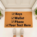 Personalized checklist doormat for front porch entry, featuring a natural coir fiber welcome mat with black text that reads Keys, Wallet, Phone, and a customizable line for your own text, perfect for a funny housewarming home