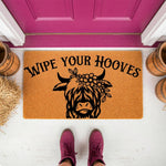 Highland Cow Wipe Your Hooves doormat featuring a floral cow illustration on natural coir fiber, perfect for a farmhouse porch entry, this funny welcome mat adds rustic charm to your home entrance with its durable outdoor design.