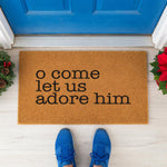 a door mat that says o come let us adore him