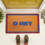 Hey coir doormat with a colorful blue and red border, featuring a modern welcome mat design for your front porch entry.