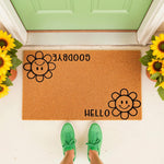 Funny flower doormat with a sad face saying goodbye and a happy face saying hello, this natural coir welcome mat features a playful floral design for your front porch decor and makes a unique housewarming entry rug for any home