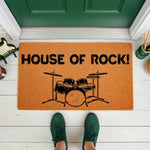 House of Rock drum set doormat for musicians, featuring a natural coir fiber welcome mat with a black drum kit graphic on a front porch, perfect for music lovers and home decor enthusiasts looking for a unique, stylish entryway