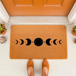 Moon phase doormat featuring a black celestial design on a natural coir welcome mat, placed on a porch for a boho home entrance.
