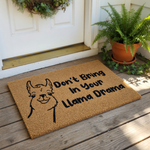 A doormat with a cartoon llama and the text "Don't Bring In Your Llama Drama" printed on it.