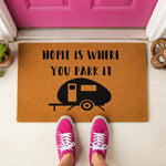 a door mat that says home is where you park it