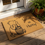 Sweet as Hunny coir doormat featuring a cute cartoon bear illustration with a honey pot, this natural fiber welcome mat is a charming front porch decor piece for any home entrance or housewarming gift for bear lovers.