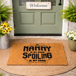 Nanny doormat with funny quote, a natural fiber welcome mat for front porch decor featuring bold black text that says Nanny is my name spoiling is my game, perfect for a farmhouse entryway or a personalized housewarming front