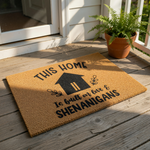 Funny welcome doormat featuring a house icon and the text This Home Is Built On Love And Shenanigans, this natural coir fiber outdoor rug is a durable front porch mat that adds a humorous touch to your home entryway decor and