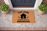 Funny coir doormat with the text This Home Is Built On Love And Shenanigans, featuring a house icon on a natural fiber welcome mat for a front porch entry, creating a humorous and inviting home decor look for your front door