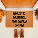 Funny Halloween doormat with text Ghosts Goblins and Ganja Oh My printed on natural coir fiber, featuring a festive porch setting with pumpkins and boots for a seasonal outdoor welcome mat that adds humor to your home entrance