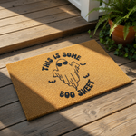 Funny Halloween doormat featuring a ghost wearing sunglasses with the text This Is Some Boo Sheet, a natural coir fiber welcome mat for your front porch decor that adds a humorous touch to your seasonal home entryway and fall