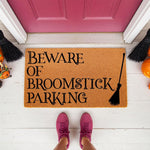 Beware of Broomstick Parking Halloween doormat featuring a natural coir fiber welcome mat with black text and a broom graphic, perfect for fall porch decor and spooky entryway floor mats for a festive seasonal home entrance.