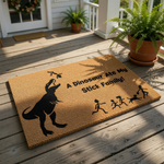 Funny dinosaur doormat featuring a large T-Rex eating a stick figure family, with the text A Dinosaur Ate My Stick Family printed on natural coir fiber.