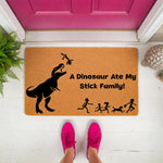 Funny dinosaur doormat featuring a T-Rex eating a stick figure family, this natural coir welcome mat has a humorous design for front porch decor, making it a unique housewarming gift for families who love prehistoric animal