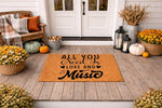 Music lover welcome doormat with black text reading All You Need Is Love And Music on a natural coir fiber mat, displayed on a fall porch with pumpkins and flowers for a stylish outdoor entryway decor and home entrance floor mat.
