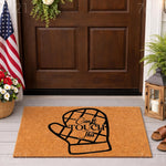 Funny kitchen oven mitt doormat featuring a humorous quote on a natural coir fiber welcome mat, perfect for a front porch entry.