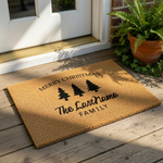 Personalized Merry Christmas doormat with three black pine trees and custom family name text, featuring a natural coir fiber welcome mat design for holiday home decor, front porch entry, and festive winter housewarming entryway