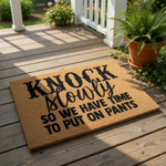 Funny Knock Slowly So We Have Time To Put On Pants doormat, a natural coir fiber welcome mat with bold black typography, perfect for a humorous front porch entry, housewarming decor, or a funny apartment door rug for your home