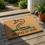 Funny snake doormat featuring a hand-drawn cartoon snake on green grass with the text no step on snek, this natural coir fiber welcome mat is a humorous front porch decor piece for reptile lovers and those seeking unique home