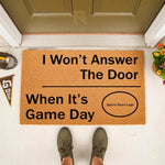 Game day doormat for sports fans featuring a funny I Won't Answer The Door When It's Game Day message on natural coir fiber, perfect for a front porch entrance with a football helmet and pennant decor for a sports themed home