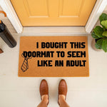 Funny adulting doormat with a necktie graphic, this natural coir welcome mat features bold black text reading I Bought This Doormat To Seem Like An Adult, perfect for a humorous front porch entryway or a housewarming apartment