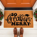 So Freakin Merry Christmas doormat featuring a festive Santa hat design on a natural coir welcome mat, placed on a front porch with holiday greenery decor for a funny seasonal entryway floor rug that greets guests with holiday