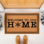 Winter snowflake welcome doormat for front porch decor, featuring a natural coir fiber mat with black text reading Welcome To Our Home and a snowflake icon, perfect for holiday entryway floor mats and seasonal home entrance rugs.