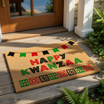 A mat with the text "Happy Kwanzaa" written on it, along with a banner of flags and geometric shapes.