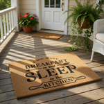 Funny kitchen doormat with text reading If You Want Breakfast In Bed Sleep In The Kitchen, featuring a natural coir fiber welcome mat design that makes a humorous housewarming gift for home decor and entryway floor mats.