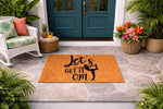 Yoga doormat with Let's Get It Om text and a dancer silhouette, this natural fiber welcome mat is a funny front porch rug for yoga lovers, meditation enthusiasts, and home decor fans looking for a stylish outdoor entry floor mat.