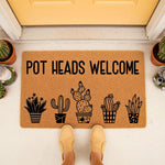 Pot Heads Welcome cactus doormat featuring a funny plant lover design on natural coir fiber, perfect as a humorous front porch welcome mat for houseplant enthusiasts and gardeners looking for unique home decor for their entryway.