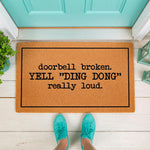 Funny doorbell broken doormat with text that says yell ding dong really loud, featuring a natural coir fiber welcome mat on a white porch floor with teal sneakers, perfect for a humorous front door entrance or housewarming gift.