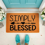Simply Blessed coir doormat featuring a black arrow and heart design, displayed on a front porch with teal shoes, making this natural fiber welcome mat a stylish home decor piece for your entryway or front door entrance.